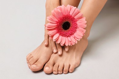 Photo of Woman with smooth feet on grey background, closeup