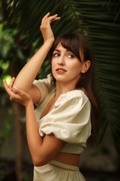 Photo of Portrait of beautiful woman posing in tropical forest