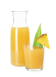 Photo of Glass with tasty pineapple juice, jug and piece of fresh fruit isolated on white