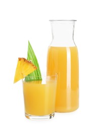 Photo of Glass with tasty pineapple juice, jug and piece of fresh fruit isolated on white