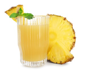 Photo of Glass with pineapple juice and pieces of fresh fruit isolated on white