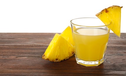 Photo of Glass with pineapple juice and pieces of fresh fruit on wooden table against white background