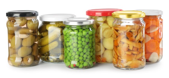 Photo of Different pickled products in jars isolated on white