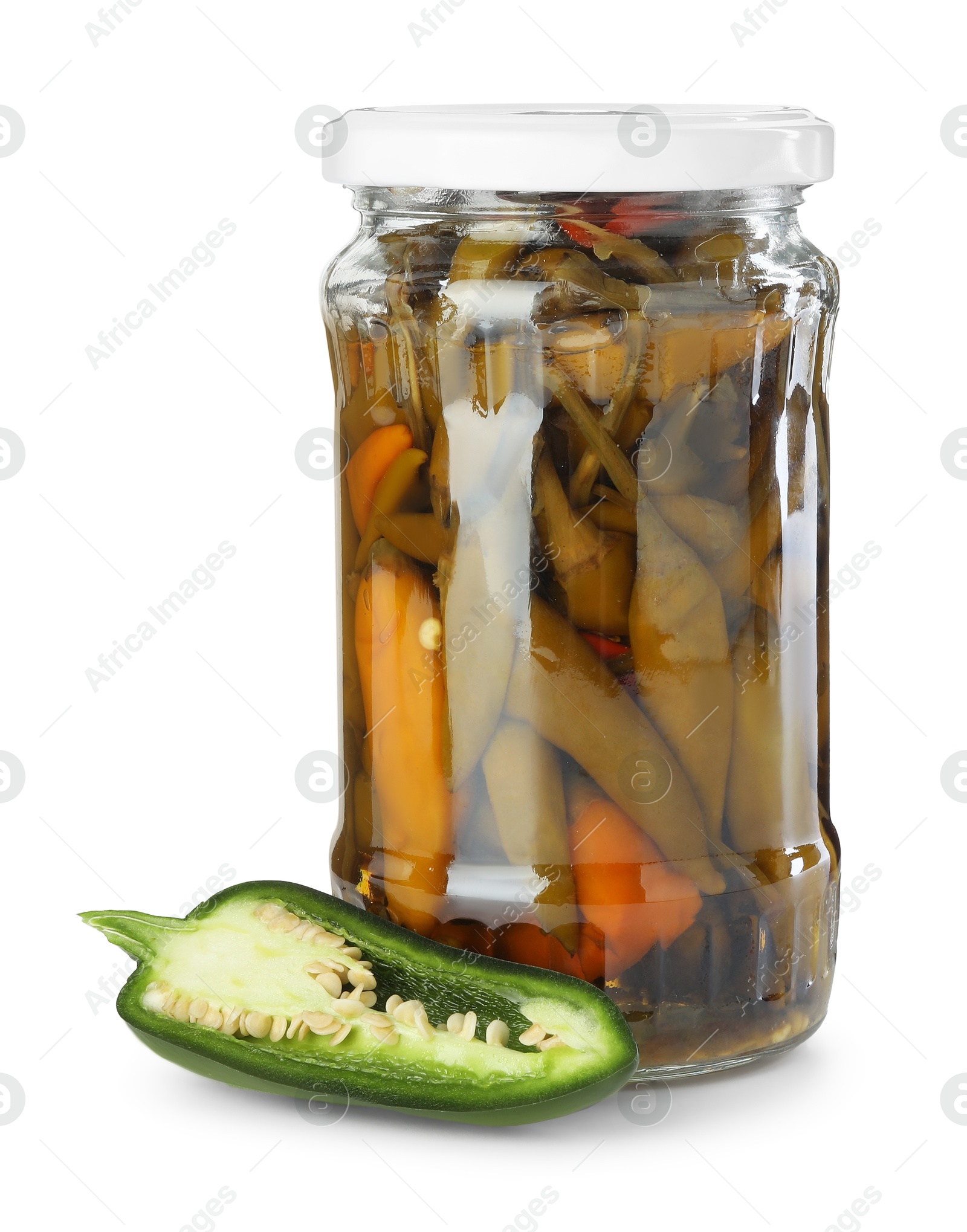 Photo of Tasty pickled jalapeno peppers in jar and fresh vegetable isolated on white