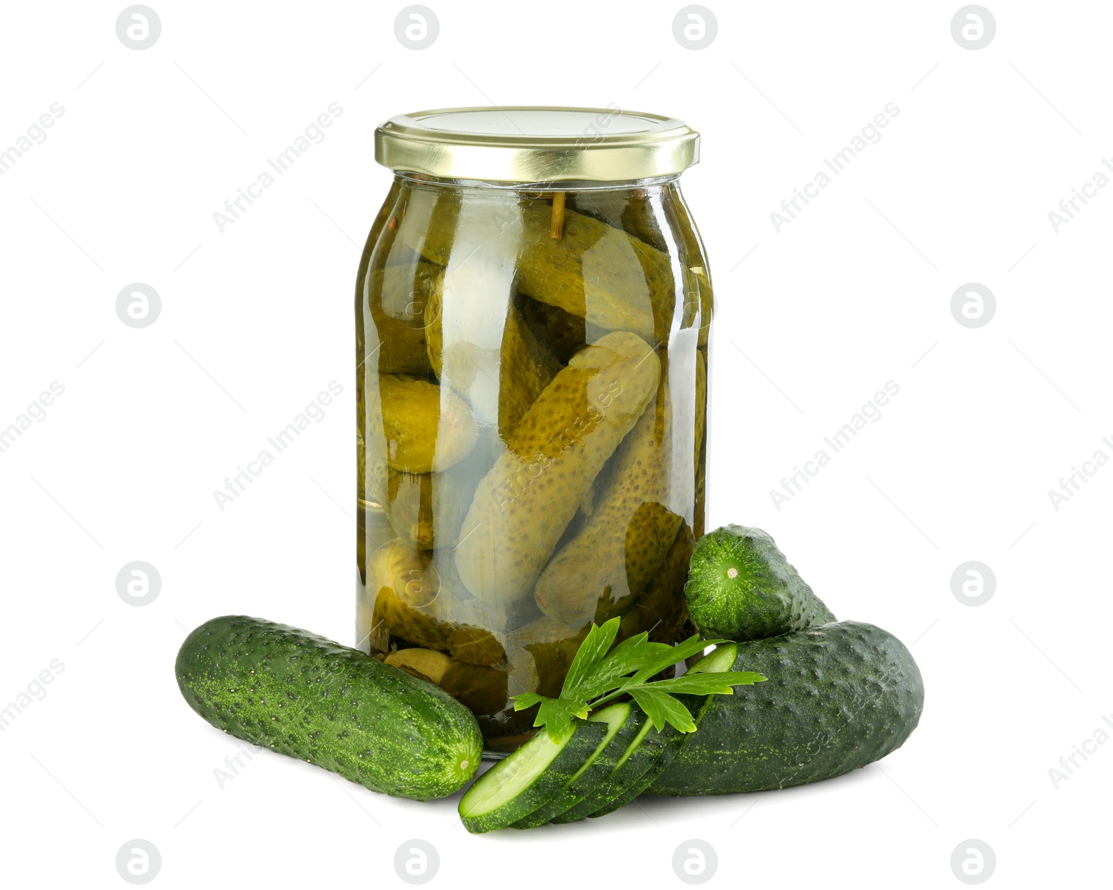 Photo of Tasty pickled cucumbers in jar, fresh vegetables and parsley isolated on white