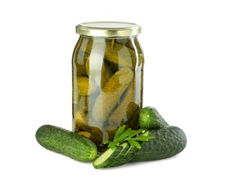 Photo of Tasty pickled cucumbers in jar, fresh vegetables and parsley isolated on white