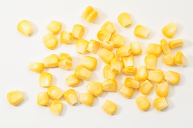 Photo of Pile of fresh corn kernels on white background, flat lay