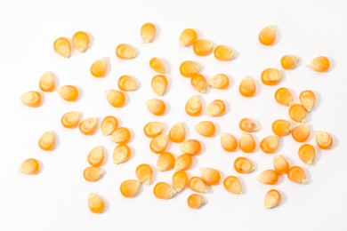 Many fresh corn kernels on white background, flat lay