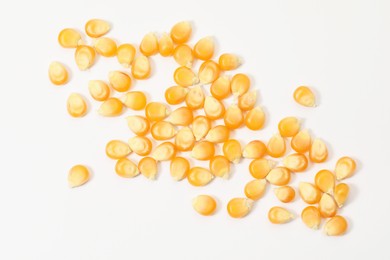 Many fresh corn kernels on white background, flat lay