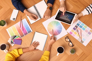 Photo of Group of designers working together at table, closeup