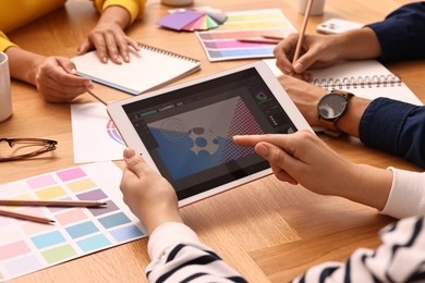 Photo of Group of designers working together at table, closeup