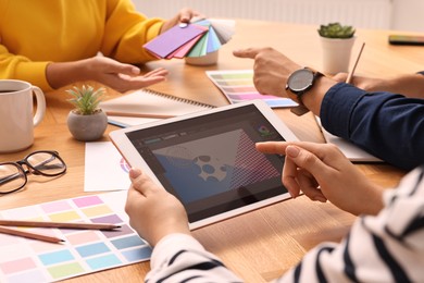 Photo of Group of designers working together at table, closeup