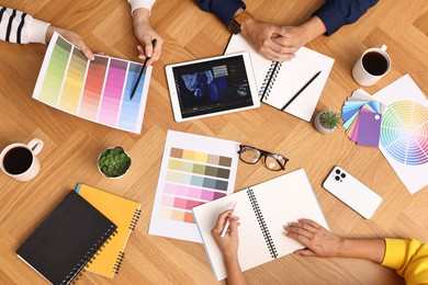 Photo of Group of designers working together at table, closeup