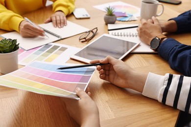 Group of designers working together at table, closeup