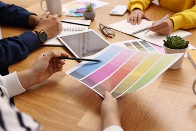 Photo of Group of designers working together at table, closeup