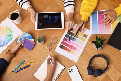 Photo of Group of designers working together at table, closeup