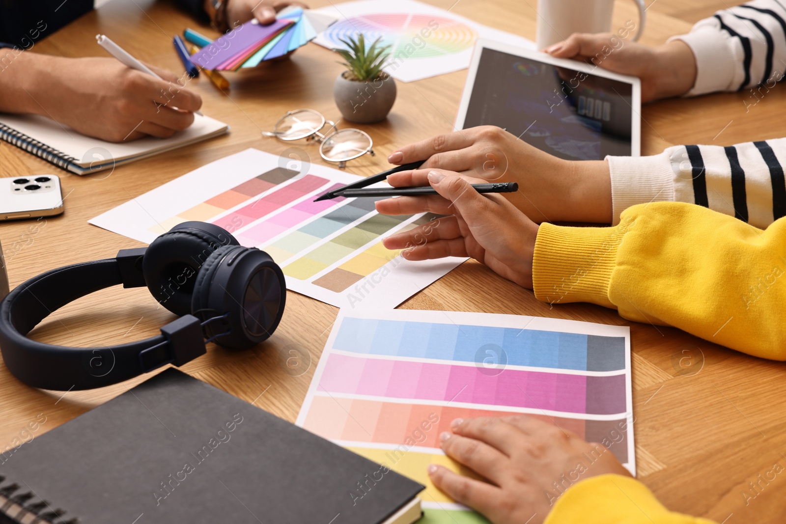 Photo of Group of designers working together at table, closeup