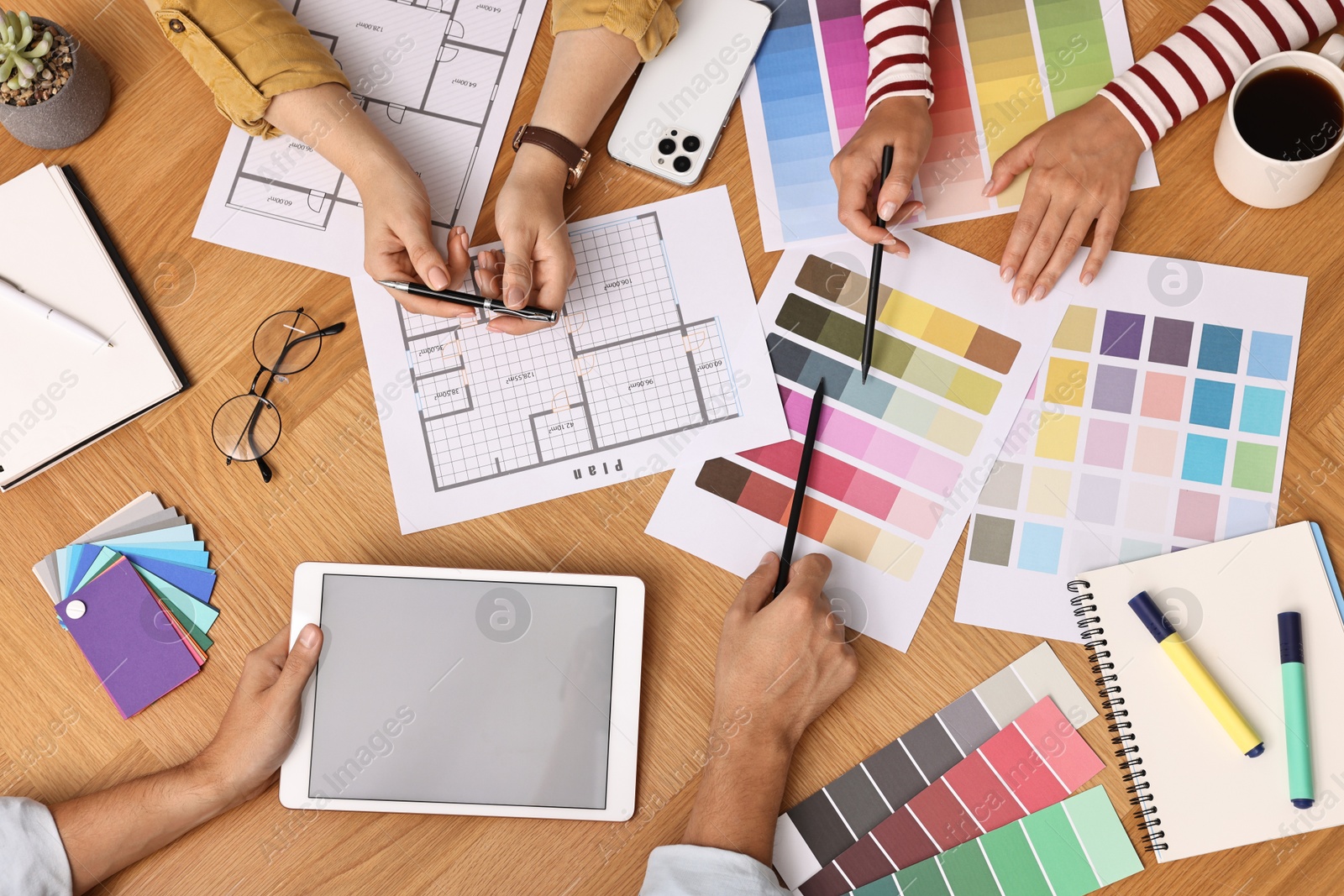 Photo of Group of designers working together at table, closeup