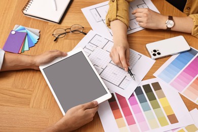 Photo of Group of designers working together at table, closeup