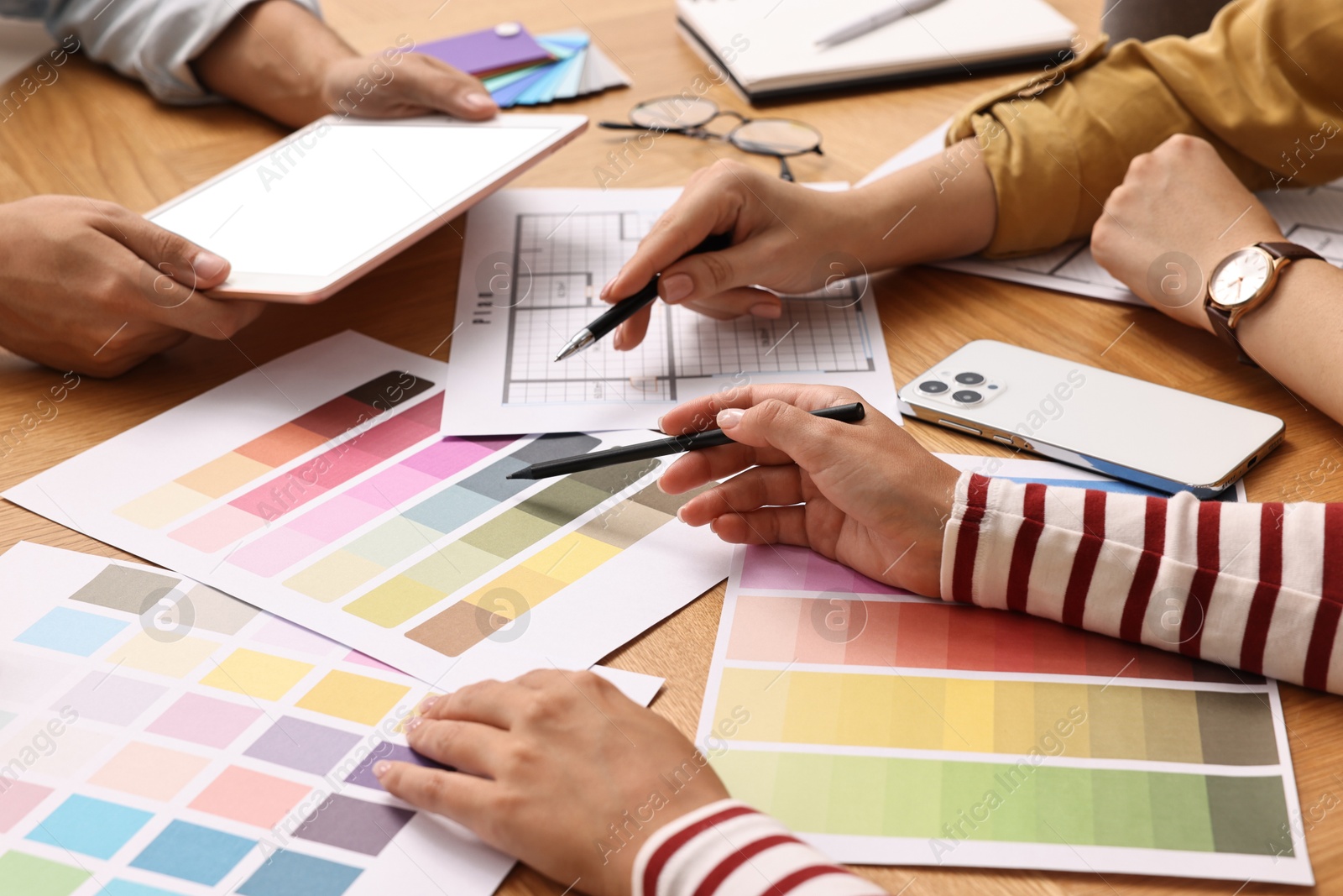 Photo of Group of designers working together at table, closeup