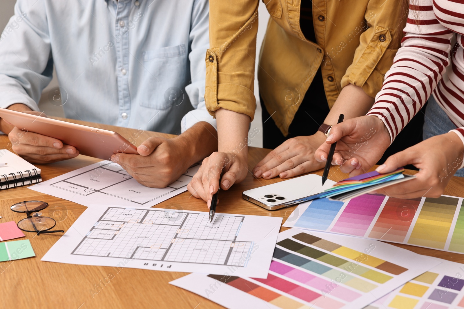 Photo of Group of designers working together at table, closeup