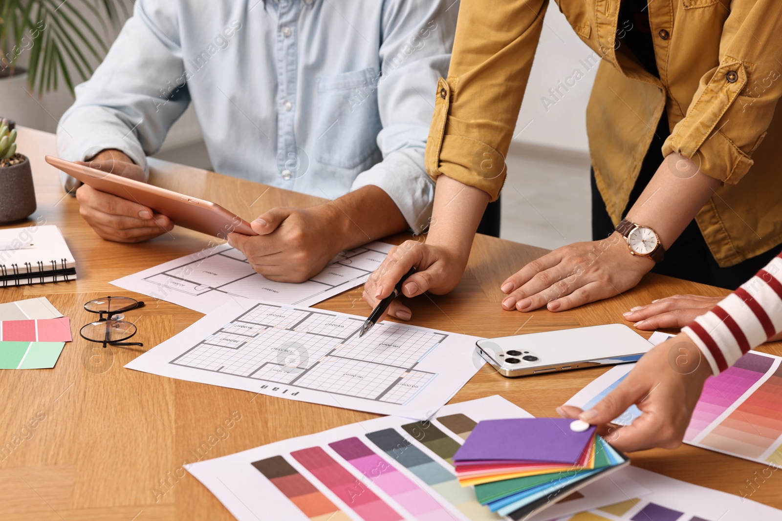 Photo of Group of designers working together at table, closeup