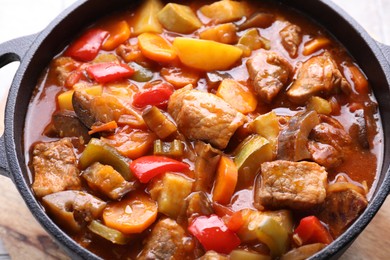 Photo of Delicious stew with vegetables in pot on table, closeup