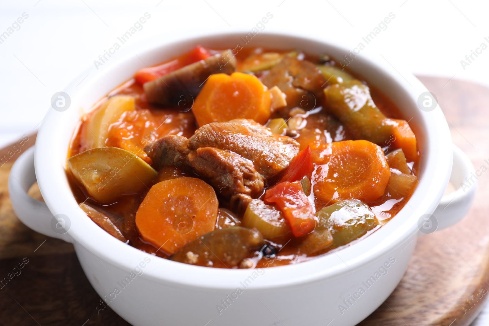 Photo of Delicious stew with vegetables in bowl on table, closeup