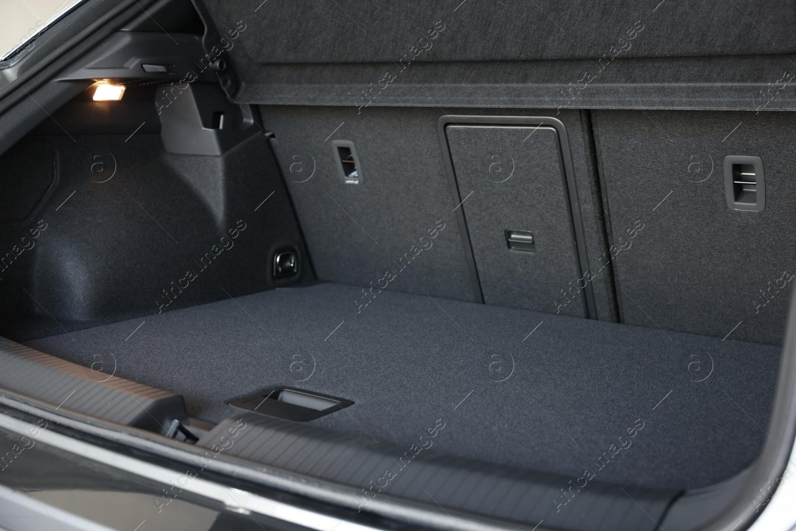 Photo of Grey soft car boot liner mat in trunk of auto