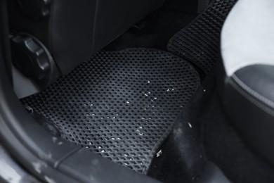 Photo of Dirty grey rubber car mat in auto