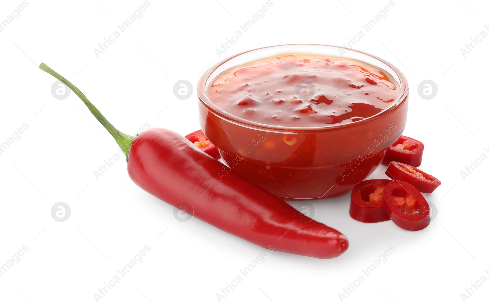 Photo of Hot chili sauce in bowl and pepper isolated on white