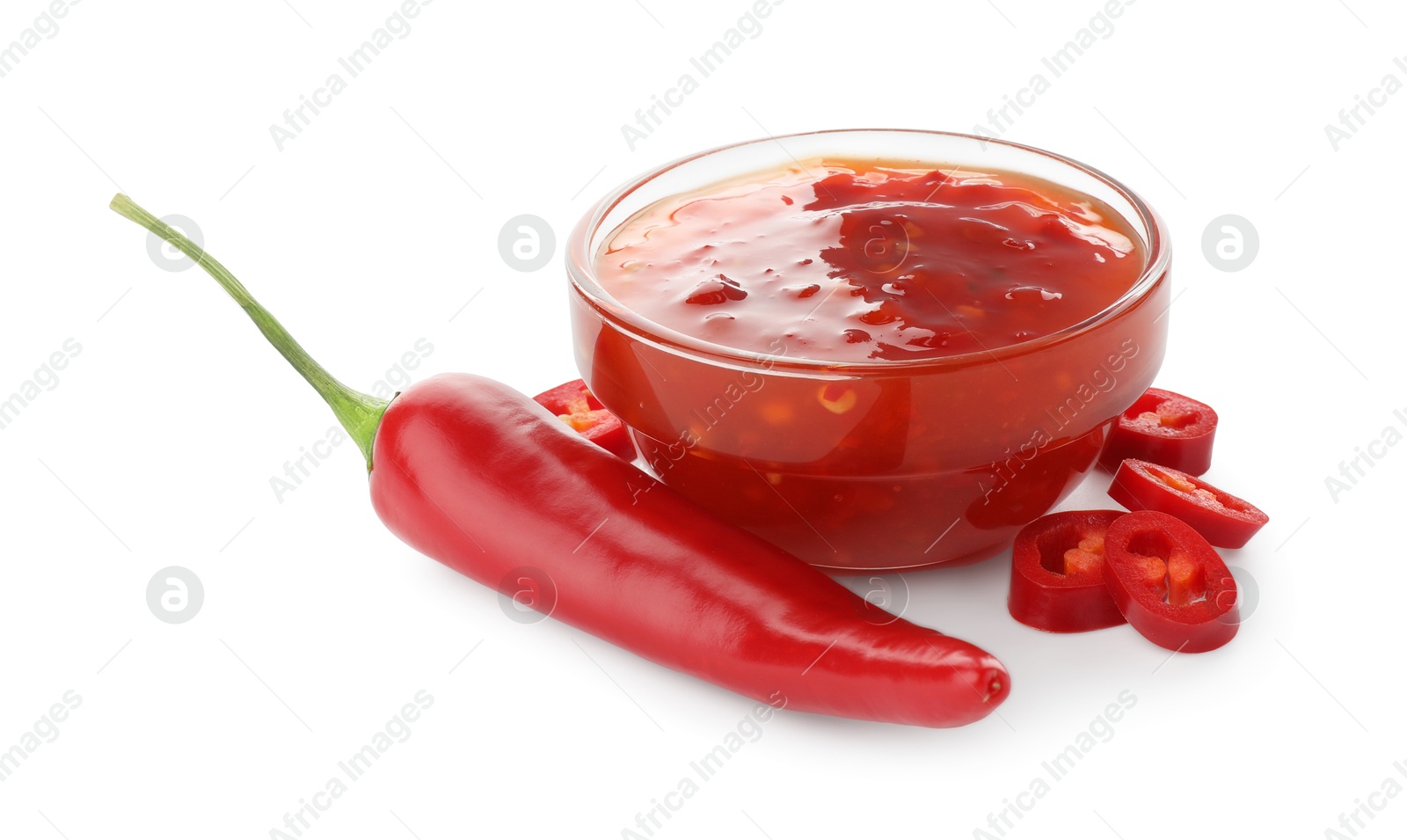 Photo of Hot chili sauce in bowl and pepper isolated on white