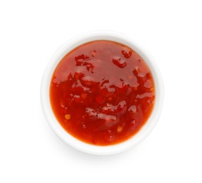 Photo of Hot chili sauce in bowl isolated on white, top view