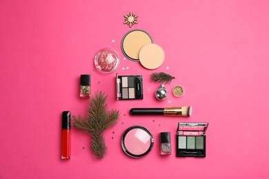 Photo of Flat lay composition with makeup products and Christmas decor on pink background