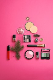 Photo of Flat lay composition with makeup products and Christmas decor on pink background