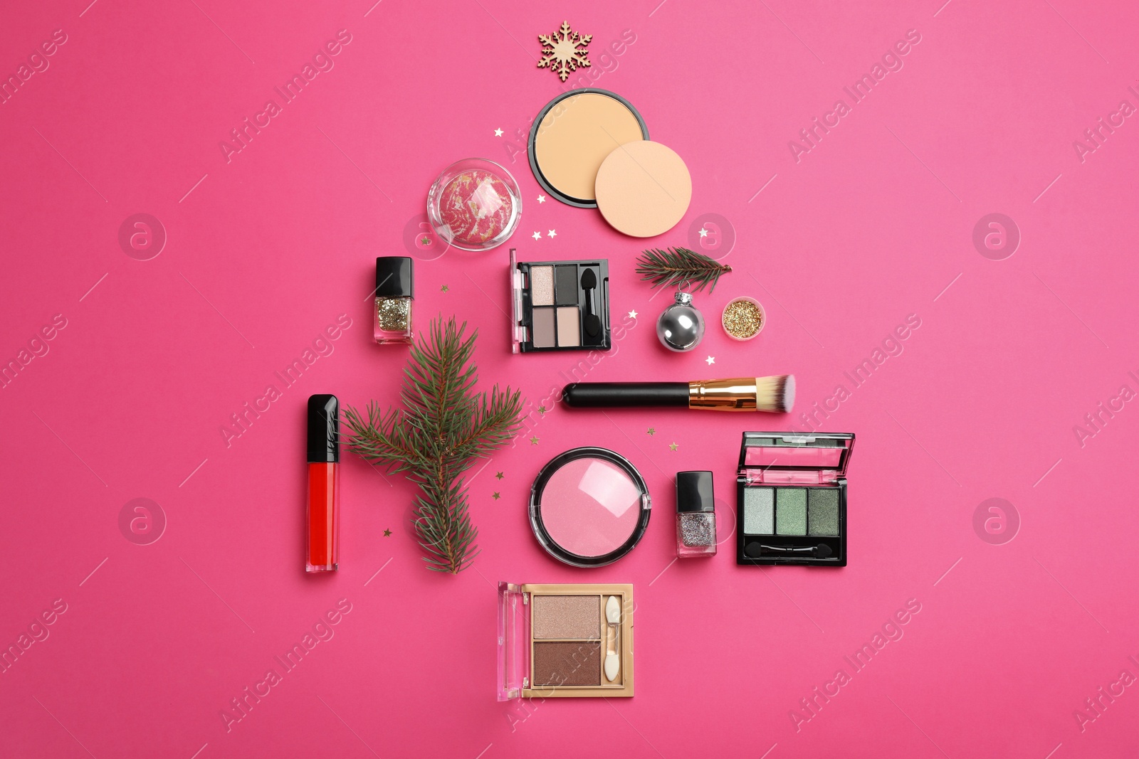 Photo of Flat lay composition with makeup products and Christmas decor on pink background