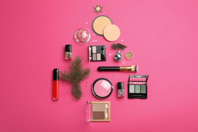 Photo of Flat lay composition with makeup products and Christmas decor on pink background