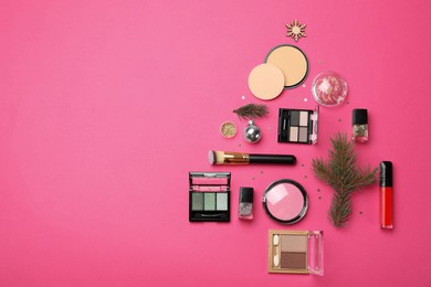 Photo of Flat lay composition with makeup products and Christmas decor on pink background. Space for text