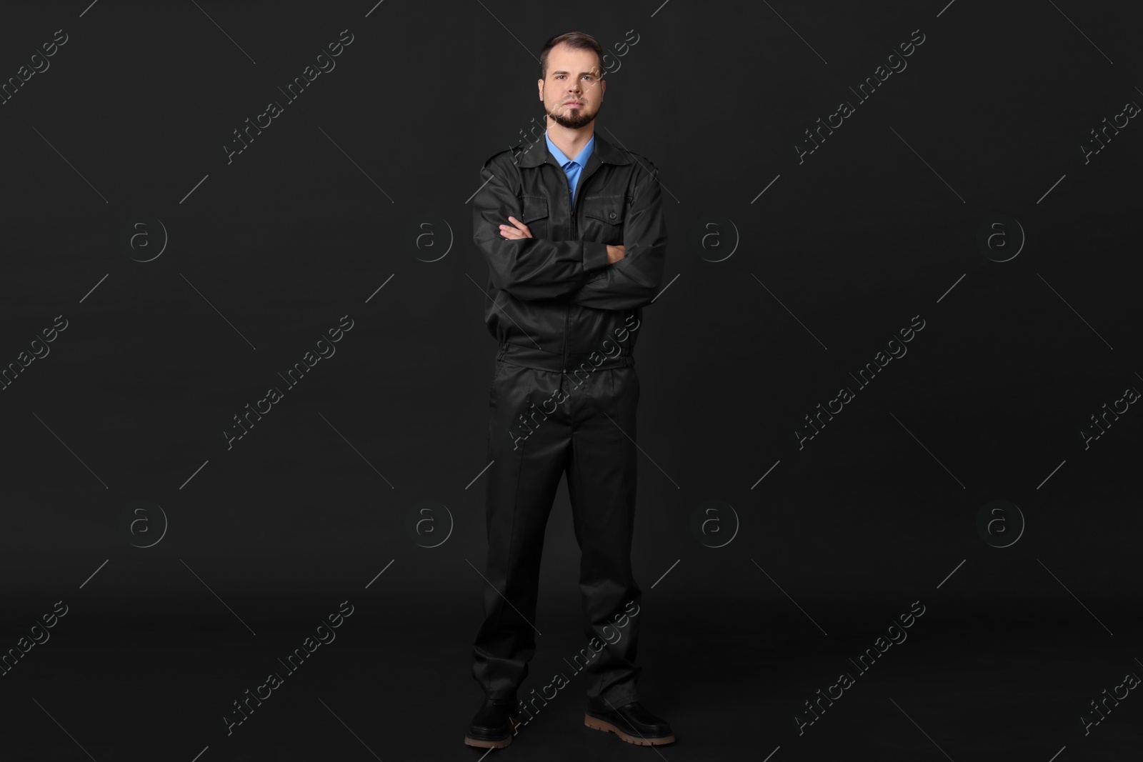 Photo of Security guard in uniform on black background