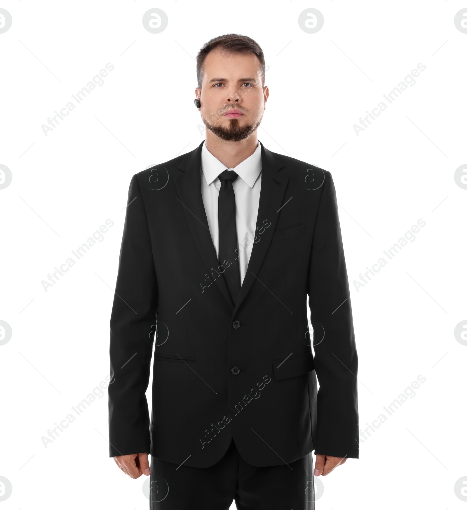 Photo of Young bodyguard in suit with earpiece isolated on white