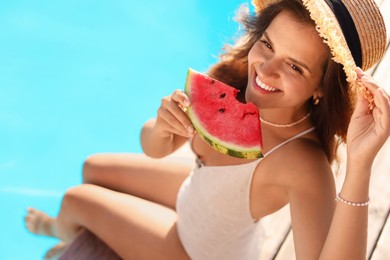 Photo of Happy woman with slice of juicy watermelon near swimming pool outdoors