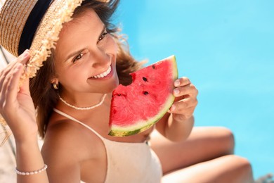 Happy woman with slice of juicy watermelon near swimming pool outdoors