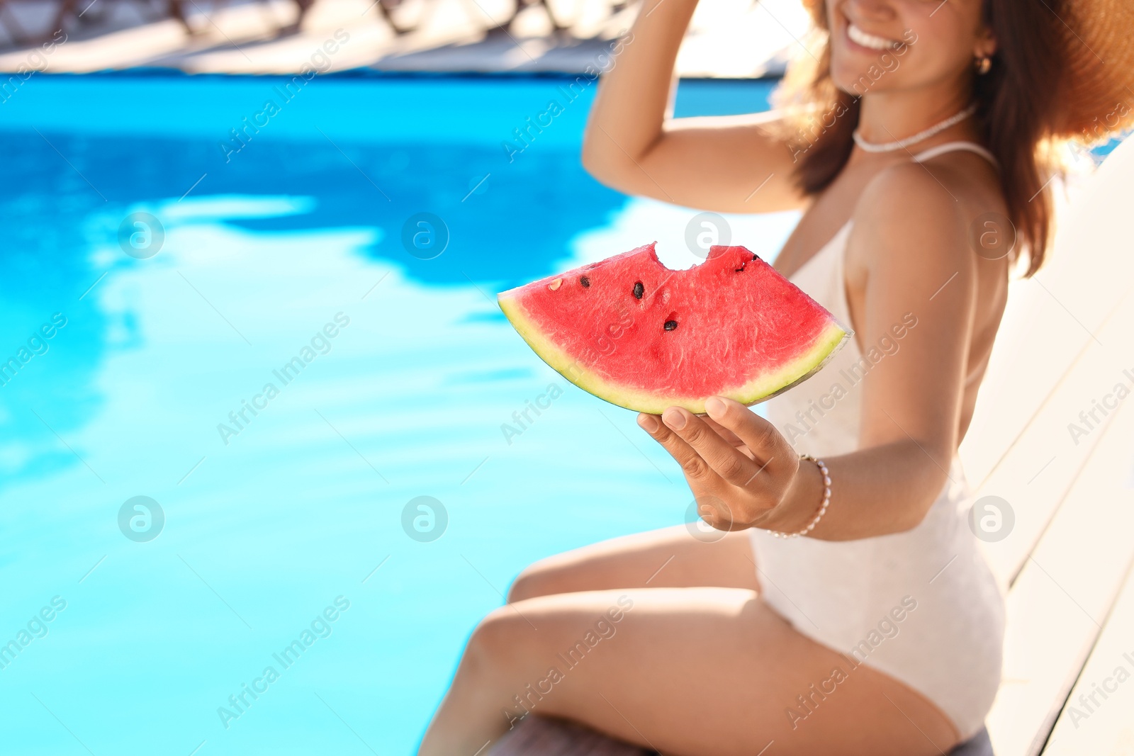 Photo of Woman with slice of juicy watermelon near swimming pool outdoors, closeup. Space for text