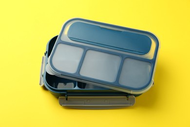 Photo of Empty plastic lunch box on yellow background