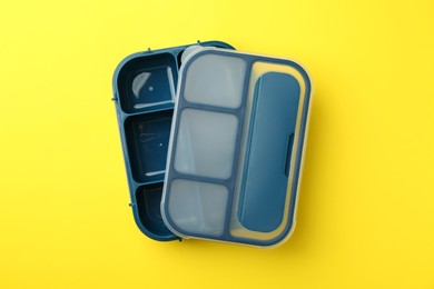 Photo of Empty lunch box on yellow background, top view