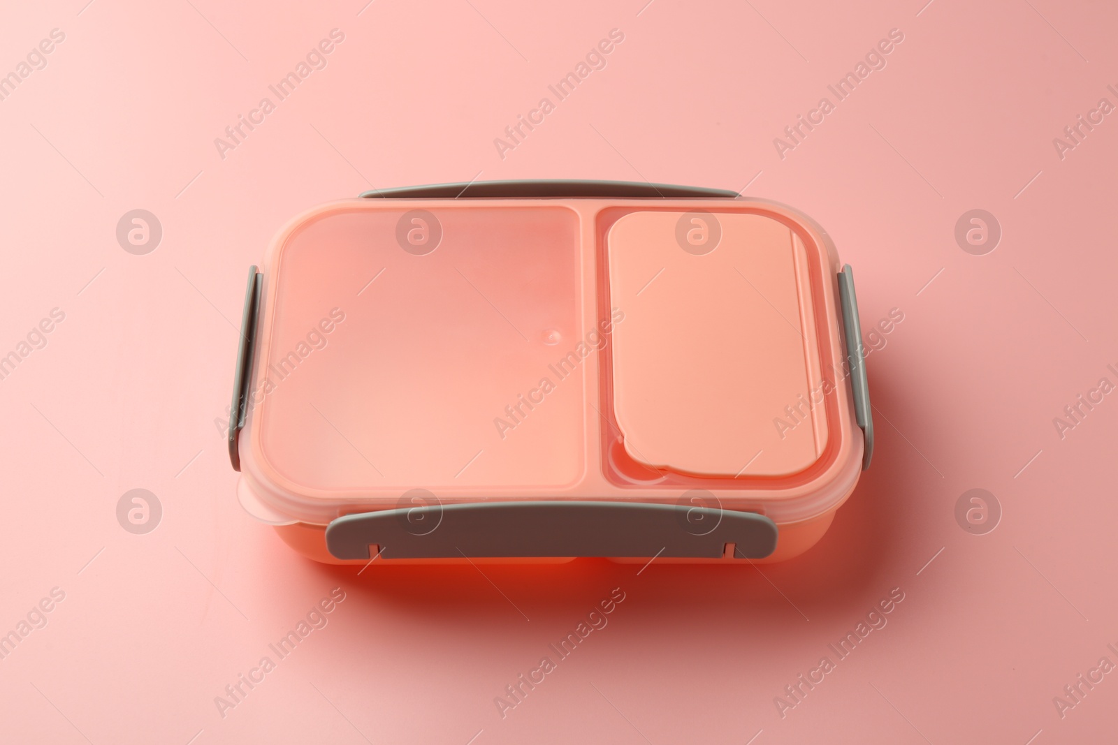 Photo of Empty plastic lunch box on pink background