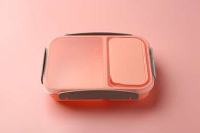 Photo of Empty plastic lunch box on pink background