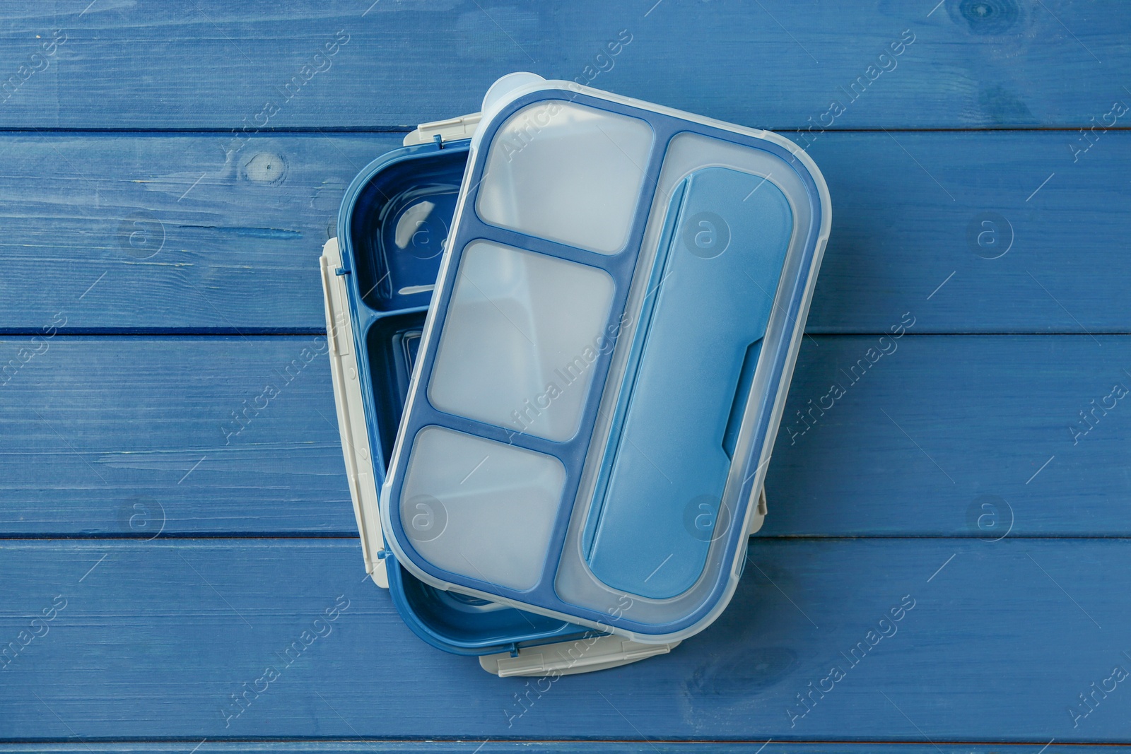 Photo of Empty lunch box on blue wooden table, top view