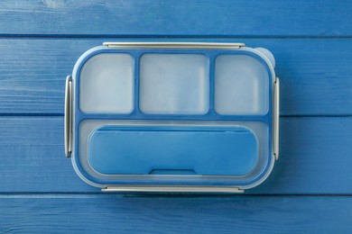 Photo of Empty lunch box on blue wooden table, top view