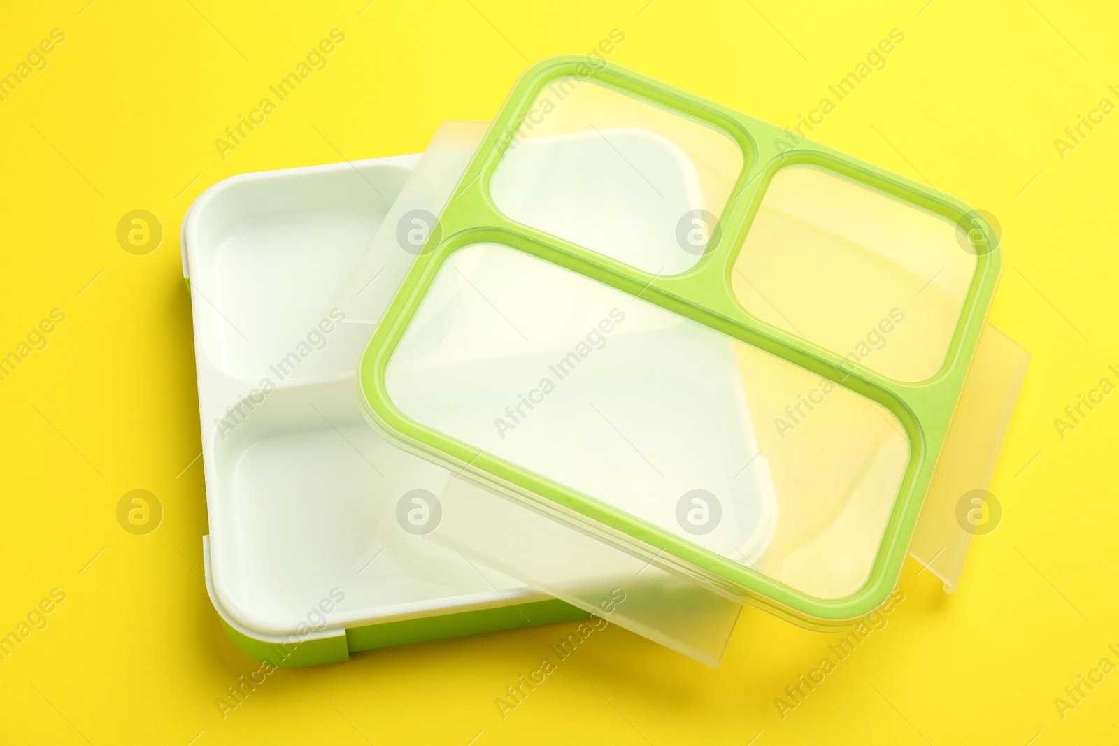 Photo of Empty plastic lunch box on yellow background